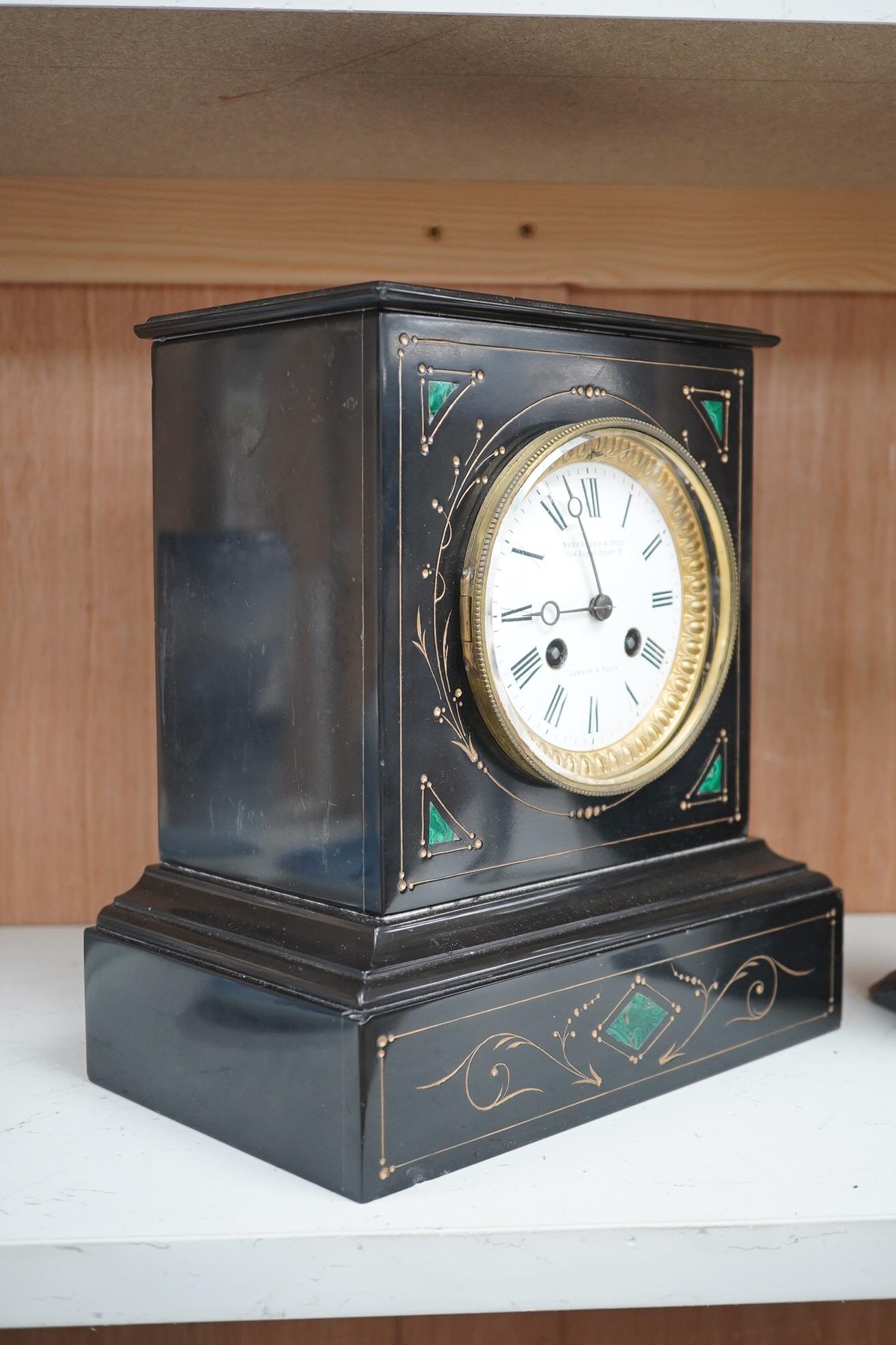 A late 19th century, French black marble eight day mantel clock, inset with malachite, retailed by Shepheard & Rees, with pendulum, no key, 26cm high. Condition - fair, minor chipping, untested